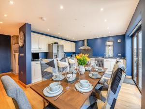 a kitchen and dining room with a wooden table and chairs at Highfields in Runswick