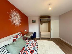 a bedroom with a bed and a desk at The Mandala Room in Thionville