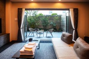 a living room with a couch and a table at Grand Inn Hakata in Fukuoka +29 photos