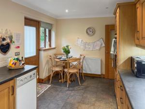 a kitchen with a table and chairs in a kitchen at Trelaw - Uk41532 in Ochiltree