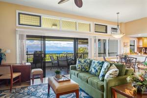 a living room with a couch and a living room with a view at Kapalua Ridge Villas 2721 in Kapalua