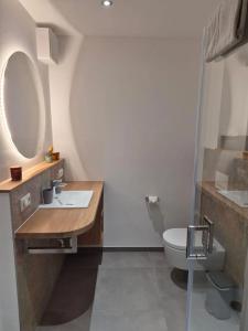 a bathroom with a sink and a toilet at Campingland Ostsee in Schashagen +28 photos