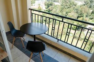 a table and two chairs on a balcony at Sunshine Home in Nanyuki