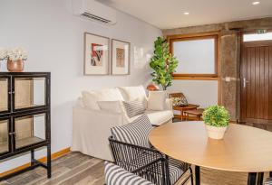 a living room with a couch and a table at LR Vintage 96 in Vila Real +10 photos