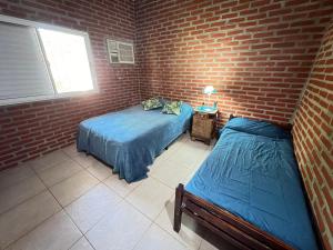 Postel nebo postele na pokoji v ubytování Casaquinta en Corrientes con Pileta