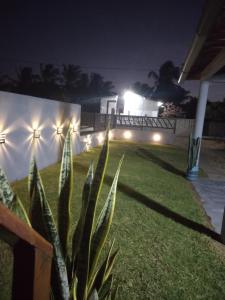 a backyard at night with lights on a fence at Brisa Oceanica in Itarema
