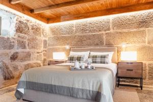 a bedroom with a large bed with two lamps at LR Vintage 96 in Vila Real