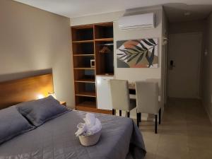 a bedroom with a bed and a table and chairs at Suite Rincon del Sol in Pinamar +16 photos