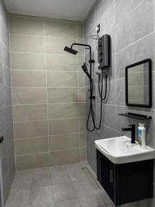 a bathroom with a shower and a sink at Habib Roomstay in Jeli