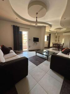 a living room with two couches and a table at Paradise residence in Dumyāţ al Jadīdah