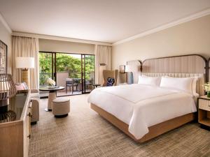 a bedroom with a large bed and a living room at Fairmont Orchid in Waikoloa +198 photos
