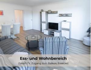 a living room with a couch and a tv at Ferienwohnungen Riese - Sternenzauber in Arnsberg