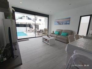 a living room with a couch and a table at Casa Kempie in San Javier