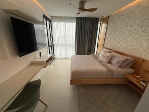 a hotel room with a bed and a television at SYC Hotel Boutique in Arauca
