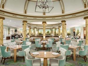 a restaurant with tables and chairs and a ceiling at Fairmont San Francisco in San Francisco