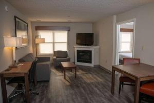 a living room with a couch and a fireplace at Hawthorn Suites in Erie