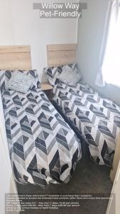 a bedroom with two beds with black and white pillows at Parkdean Camber Sands sleeps 8 Pet Friendly - ref-ww242 in Camber +31 photos