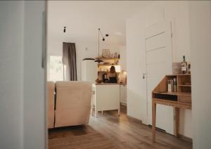 a living room with a couch and a kitchen at MISI domek in Kadłubówka +29 photos