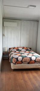 a bed in a bedroom with a wooden floor at Casa Campo in Cufré