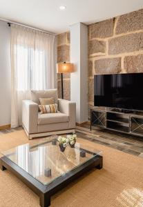 a living room with a couch and a tv at LR Vintage 86 in Vila Real