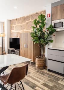 a kitchen with a table and a potted plant at LR Vintage 86 in Vila Real +11 photos