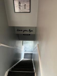 a staircase with a sign that reads love youlez at Apartment 288 in Lower Swanwick