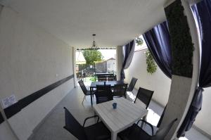 a dining room with a table and chairs and a window at Vila Rares in Costinesti