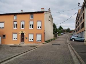 an orange building on the side of a street at Louise's Loft in Boulay - Moselle