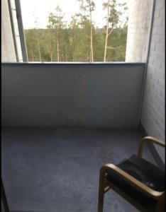 a empty room with a bench in front of a window at Kumpukuja apartment in Kouvola
