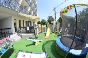 a playground with a slide and a play equipment at Vila Rares in Costinesti