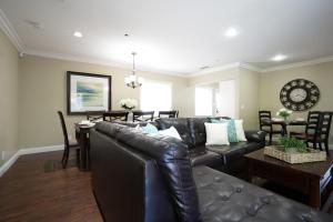 a living room with a leather couch and a table at Destination #11 in Anaheim