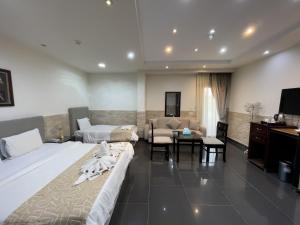 a hotel room with two beds and a living room at Best View Pyramids Hotel in Cairo