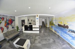 a living room with a couch and a large mural at Vila Rares in Costinesti