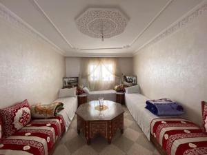 a living room with two couches and a table at Dar Wafae in Rabat