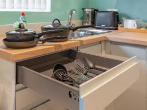 a kitchen drawer with dishes and utensils in it at Hilltop Apartment 3 - Uk50595 in Earl Shilton