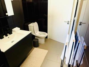 a bathroom with a white toilet and a sink at Stylish 3-bedroom flat in Funchal in Funchal +24 photos