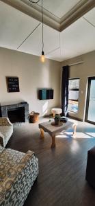 a living room with a couch and a table at Lazél Apartments in Ermelo