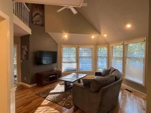 a living room with a couch and a tv at Quiet and secluded home close to TIEC in Columbus