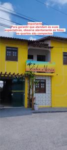 a yellow building with writing on the side of it at Pousada Vida Nova Barreirinhas MA in Barreirinhas