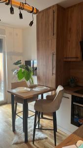 a kitchen with a wooden table and a table and chairs at DreamerLux in Loznica