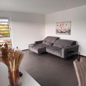 a living room with a couch and a table at Exclusives 3 Zimmer Apartment in Zimmern ob Rottweil