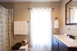 a bathroom with a sink and a shower curtain at Lucky 30 Day in Hood River +13 photos