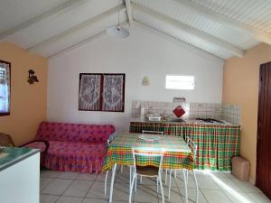 a living room with a table and a couch at L'hibiscus in Petit-Canal