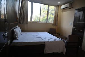 Voodi või voodid majutusasutuse Hotel arti cottage toas