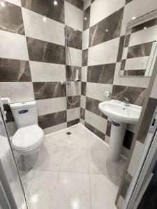 a bathroom with a toilet and a sink at Restaurant-Motel Khan Krum in Kamchiya +24 photos