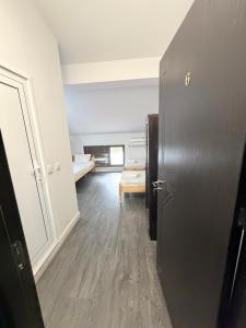 a room with a hallway with a bed and a door at Restaurant-Motel Khan Krum in Kamchiya