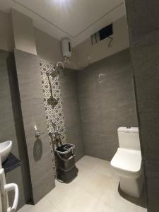 a small bathroom with a toilet and a sink at Shree Murlidhar Residency - Couple friendly in Varanasi