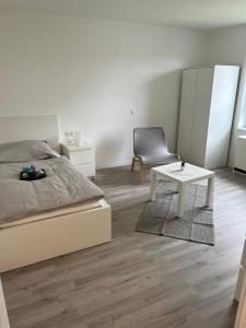 a bedroom with a bed and a table and a chair at Ferienwohnung Biberach an der Riß in Biberach an der Riß