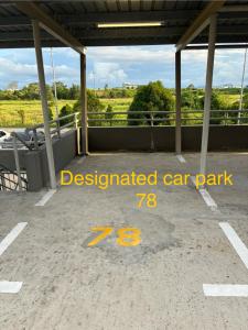 a parking lot with the words designated car park at Princeton Suite @Kuching Airport in Kuching