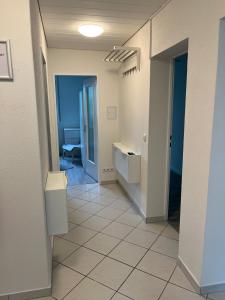 an empty room with a hallway with a bathroom at Ferienwohnung Biberach an der Riß in Biberach an der Riß